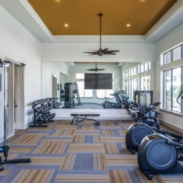 fitness center with open spaces and bright lighting through the windows