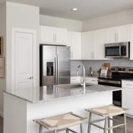 kitchen with ample counter-space, modern appliances and bright lighting